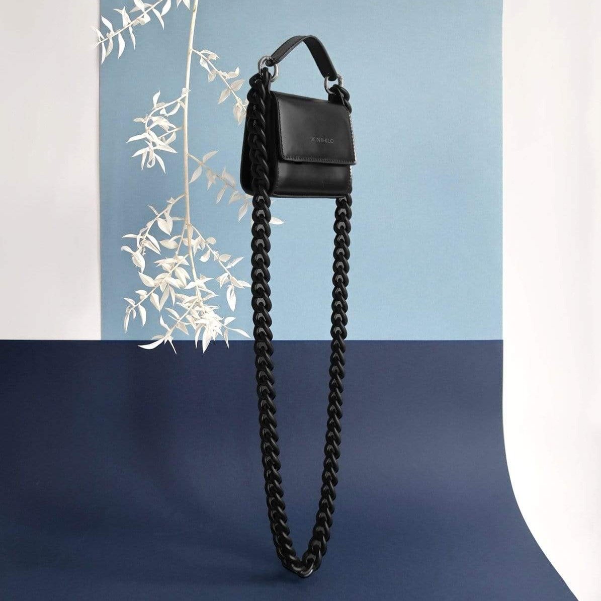 X NIHILO - TRANQUIL MINI SHOULDER BAG - BLACK Long back on blue backgrounds with white branch