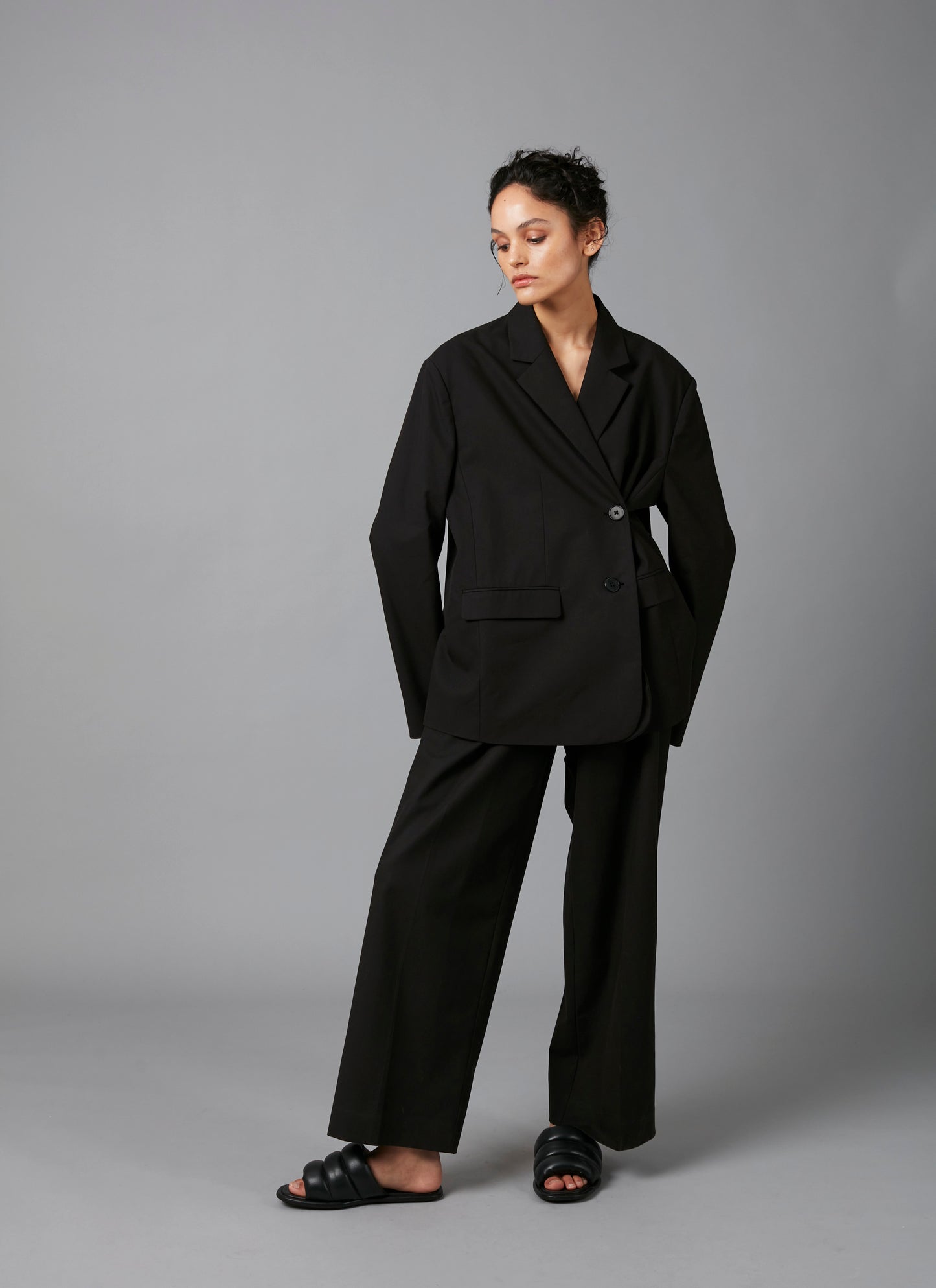 Model posing in Black Lita Oversized Cotton Tencel Tailored Jacket  and Black Sculpture Cotton Tencel Pants