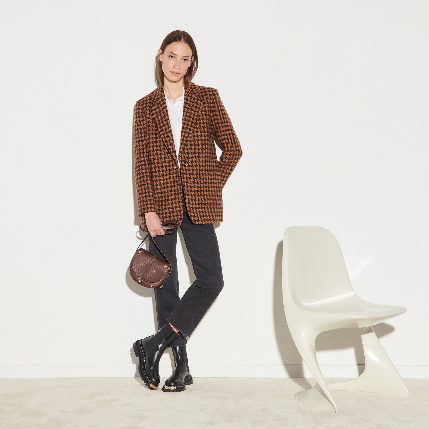 SANDRO - TAILORED JACKET - HOUNDSTOOTH Styled with bag, white chair and black boots